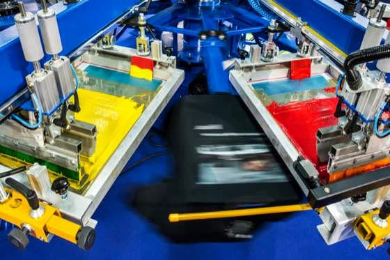 Custom apparel being produced inside Assured Print's Lanham, Maryland shop
